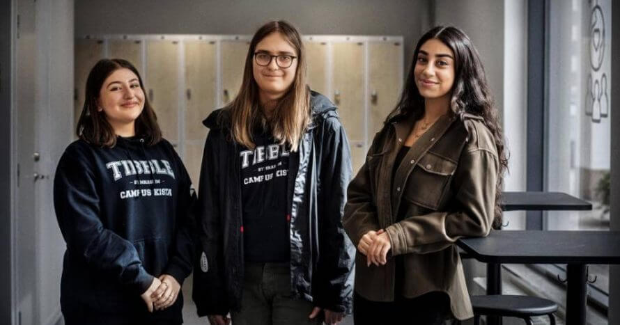 Tre elever från Tibble tittar in i kameran och ler